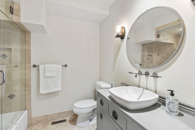 bathroom featuring vanity, tile patterned floors, and toilet