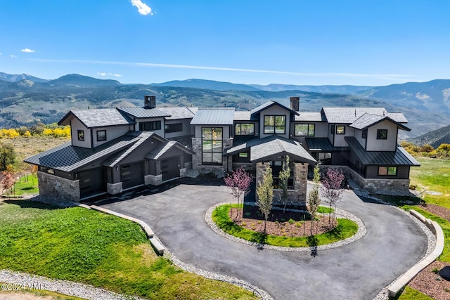 view of front of property with a mountain view and a garage