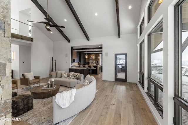 966 Webb Peak, Edwards, CO 81632 - living area featuring high vaulted ceiling, light wood-type flooring, beamed ceiling, ceiling fan, and baseboards