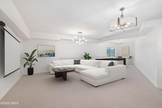 carpeted living room featuring a notable chandelier