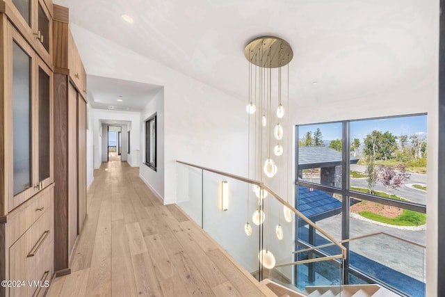 hallway with light hardwood / wood-style floors