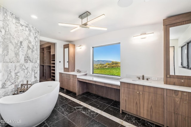 bathroom with vanity, a bath, tile walls, and ceiling fan