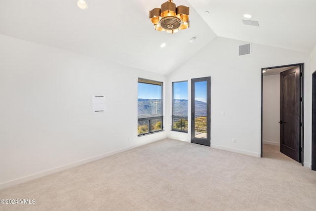 unfurnished bedroom featuring a spacious closet, high vaulted ceiling, light carpet, a mountain view, and access to exterior