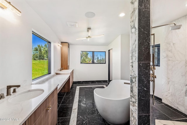 bathroom featuring vanity and separate shower and tub