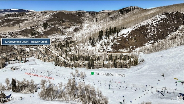 snowy aerial view with a mountain view