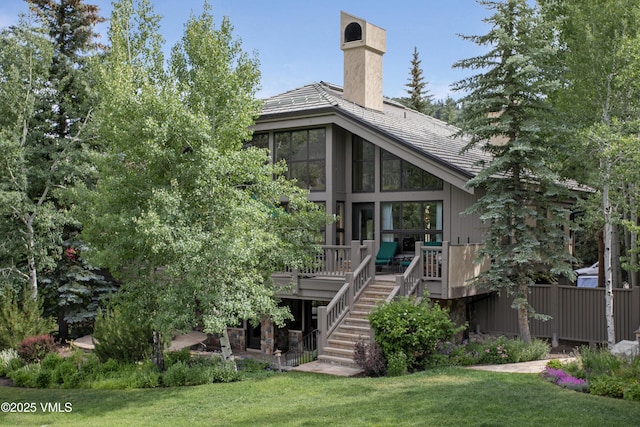 32 Greystone Ct, Beaver Creek, CO 81620 - rear view of house featuring stairway, a chimney, a wooden deck, a yard, and a sunroom