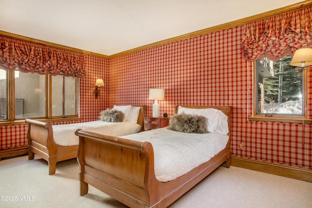 carpeted bedroom with wallpapered walls, baseboards, and ornamental molding