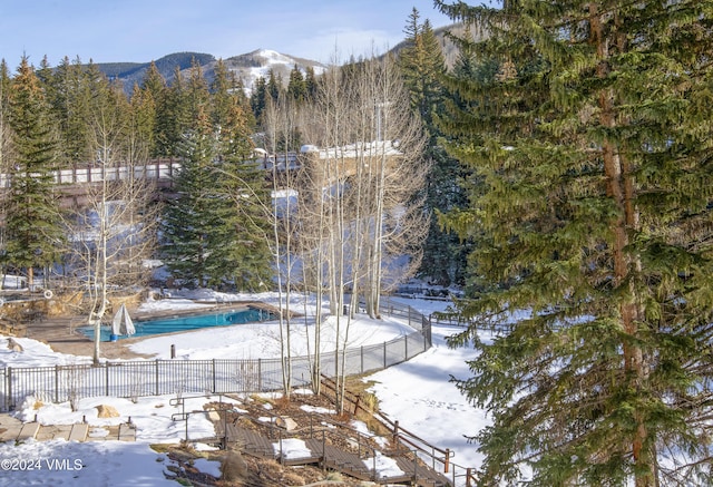 snow covered pool with a mountain view