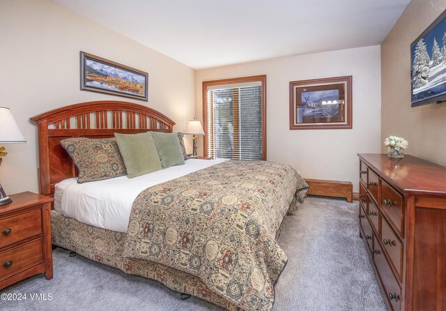 bedroom featuring light colored carpet