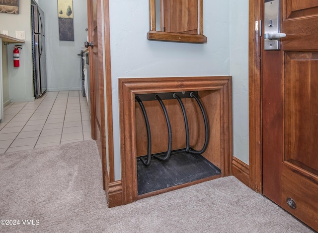 hall featuring light colored carpet