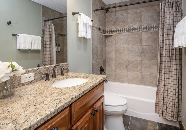 full bathroom with vanity, toilet, and shower / tub combo with curtain