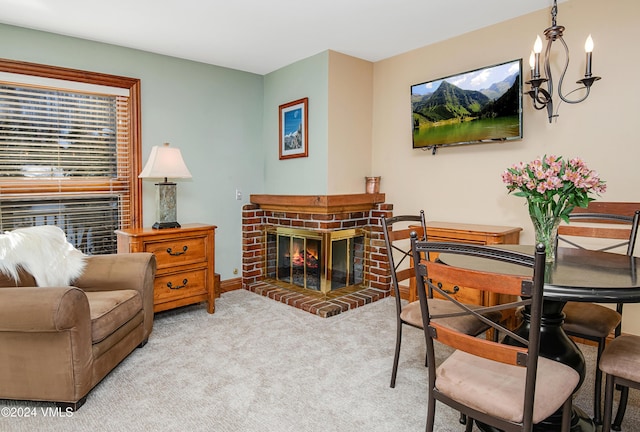 living room featuring light carpet, a notable chandelier, and a fireplace