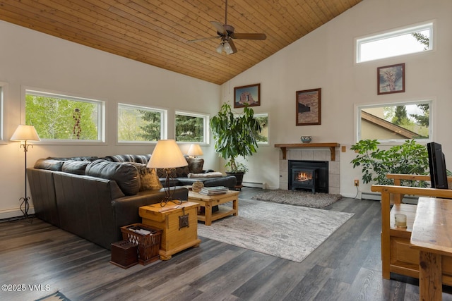 living room featuring a baseboard heating unit, high vaulted ceiling, a ceiling fan, a tiled fireplace, and wooden ceiling