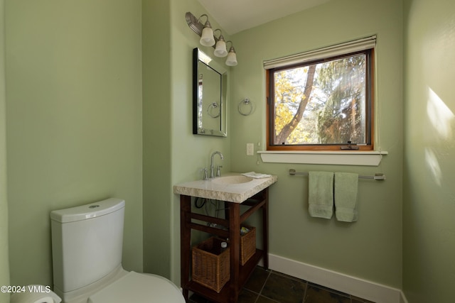 bathroom featuring vanity, tile patterned floors, and toilet