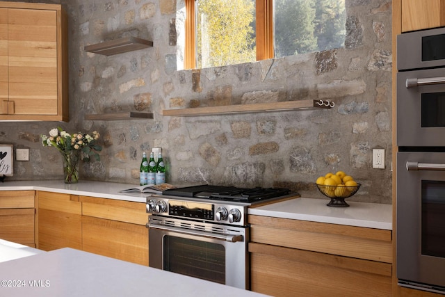 kitchen with stainless steel appliances and tasteful backsplash