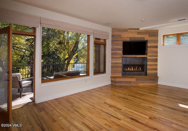 unfurnished living room with hardwood / wood-style flooring and a fireplace