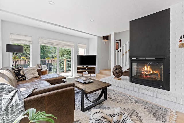1151 Casolar Del Norte Dr Unit A, Vail, CO 81657 - living area with a fireplace, wood finished floors, and stairs