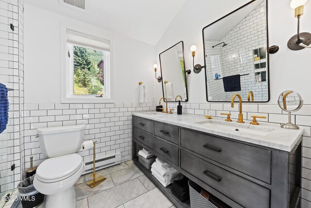 1151 Casolar Del Norte Dr Unit A, Vail, CO 81657 - bathroom featuring a baseboard radiator, tile walls, vaulted ceiling, double vanity, and a tile shower