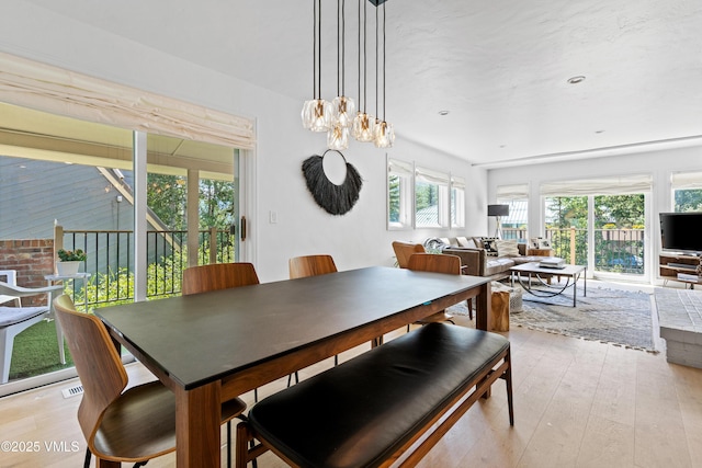 1151 Casolar Del Norte Dr Unit A, Vail, CO 81657 - dining room featuring light wood-style flooring and a chandelier