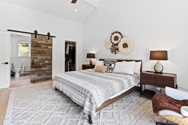 1151 Casolar Del Norte Dr Unit A, Vail, CO 81657 - bedroom with a walk in closet, ensuite bathroom, a closet, wood finished floors, and high vaulted ceiling