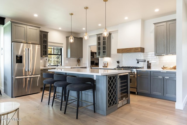 207 Aidan Rd, Eagle, CO 81631 - kitchen featuring stainless steel appliances, custom exhaust hood, a kitchen island, tasteful backsplash, and glass insert cabinets