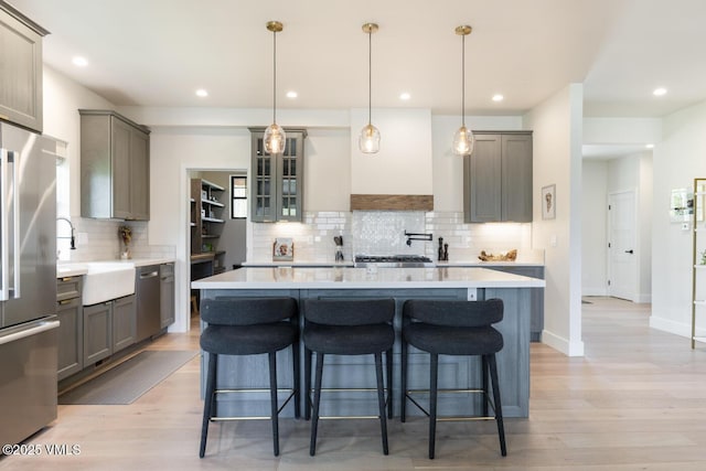 207 Aidan Rd, Eagle, CO 81631 - kitchen featuring a sink, appliances with stainless steel finishes, gray cabinetry, a breakfast bar area, and recessed lighting