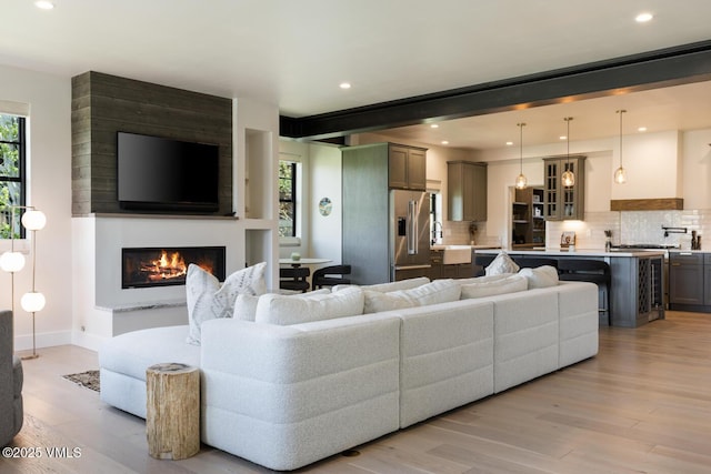 207 Aidan Rd, Eagle, CO 81631 - living room featuring a large fireplace, light wood finished floors, recessed lighting, and baseboards