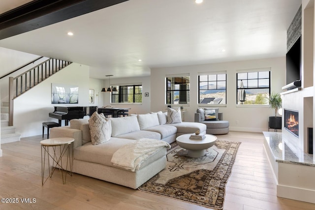 207 Aidan Rd, Eagle, CO 81631 - living area with light wood-style flooring, stairs, a glass covered fireplace, and recessed lighting