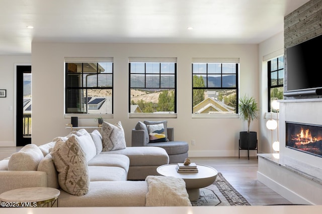 207 Aidan Rd, Eagle, CO 81631 - living room with baseboards, a large fireplace, light wood-type flooring, and recessed lighting