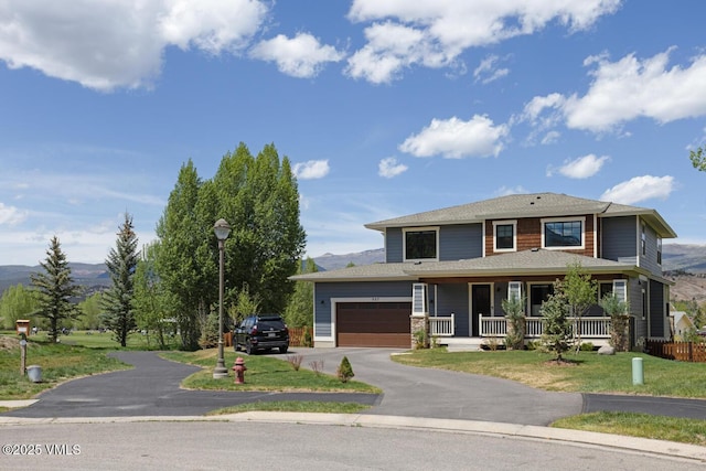 207 Aidan Rd, Eagle, CO 81631 - view of front of property featuring a porch, driveway, an attached garage, a front yard, and a mountain view