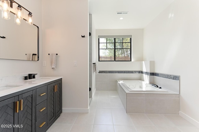 207 Aidan Rd, Eagle, CO 81631 - bathroom featuring a whirlpool tub, double vanity, tile patterned flooring, and baseboards