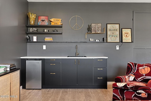 207 Aidan Rd, Eagle, CO 81631 - bar with a sink, refrigerator, and light wood-type flooring