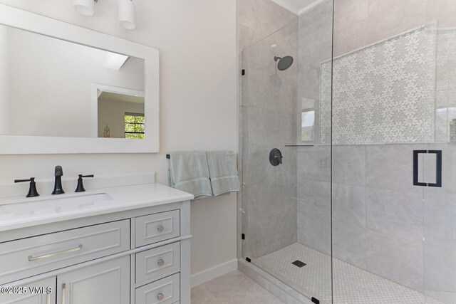 207 Aidan Rd, Eagle, CO 81631 - bathroom featuring a shower stall, vanity, tile patterned floors, and baseboards