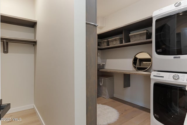 207 Aidan Rd, Eagle, CO 81631 - laundry area with stacked washer and clothes dryer, light wood finished floors, and baseboards