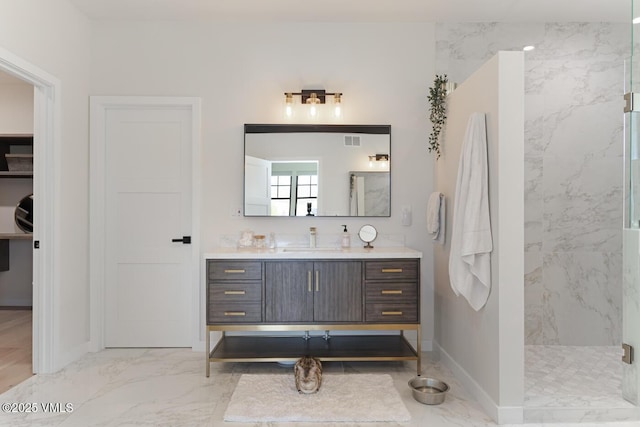 207 Aidan Rd, Eagle, CO 81631 - bathroom featuring a marble finish shower, vanity, marble finish flooring, and baseboards