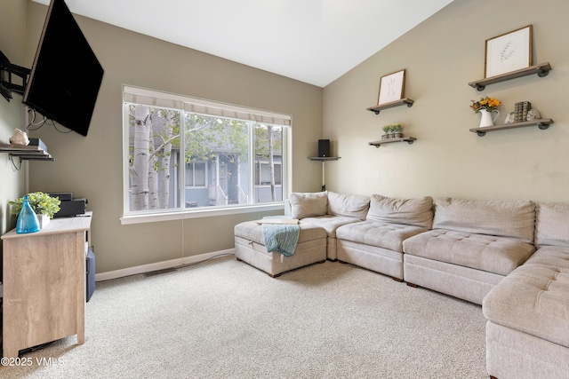 living area with carpet flooring, vaulted ceiling, and baseboards