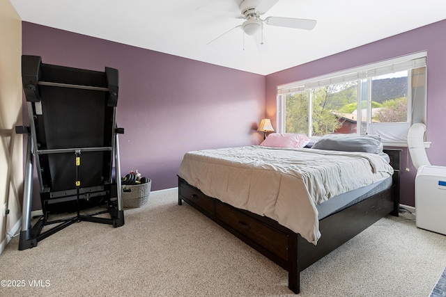 carpeted bedroom featuring a ceiling fan and baseboards