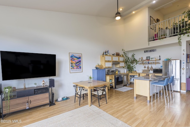 705 Nogal Rd Unit C9, Eagle, CO 81631 - living room with light wood-style flooring, a high ceiling, and ceiling fan