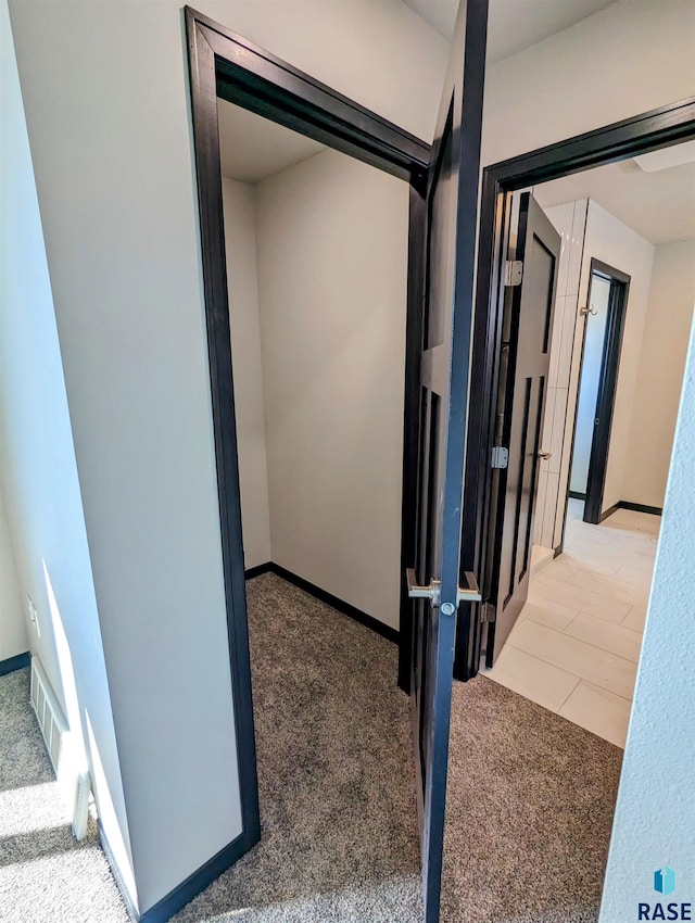 hallway with light tile floors