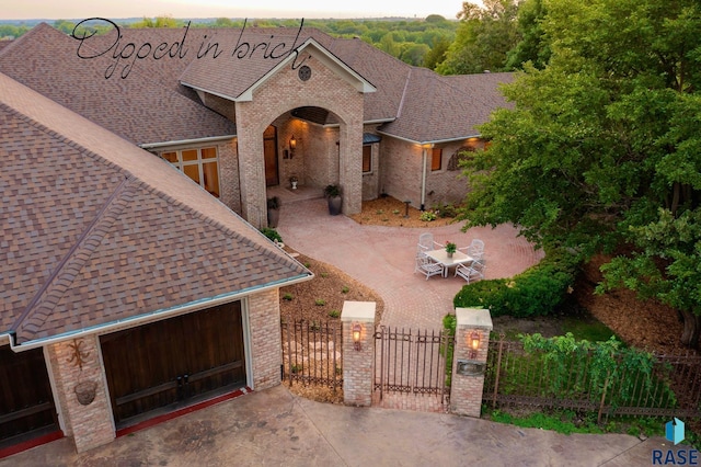 view of front of home featuring a garage and a patio