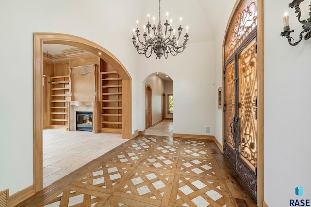 foyer entrance featuring a notable chandelier