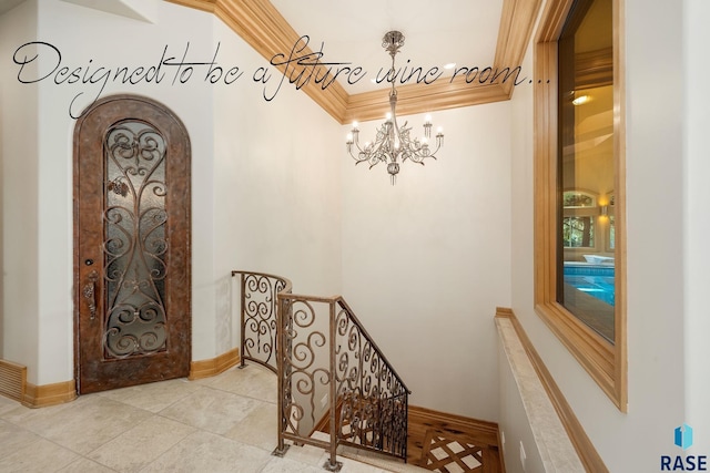 stairway featuring tile patterned floors, a chandelier, and ornamental molding