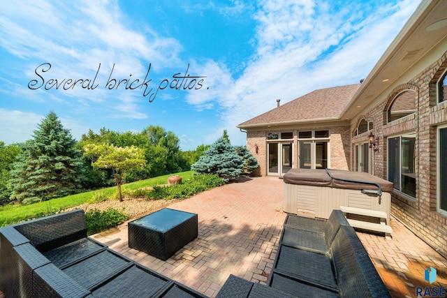 view of patio featuring outdoor lounge area and a hot tub