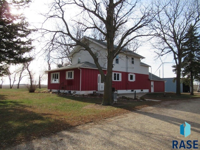 view of home's exterior with driveway, entry steps, and a yard