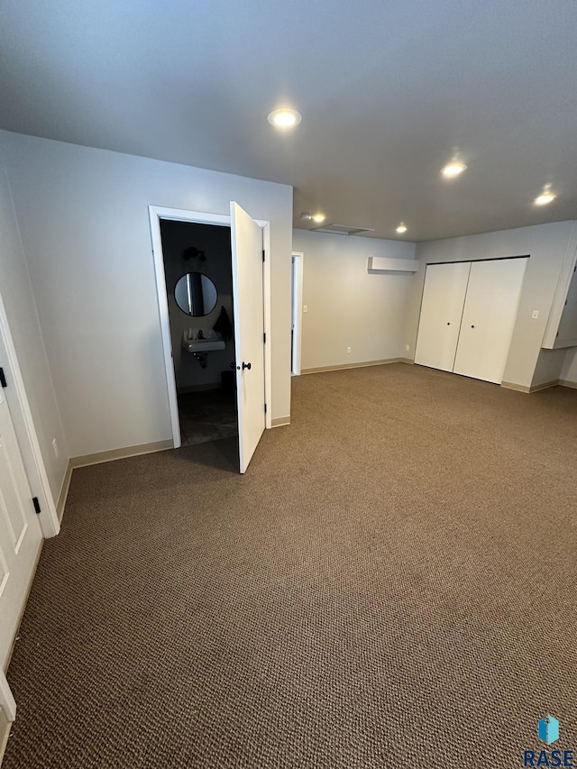 unfurnished bedroom with carpet flooring and connected bathroom