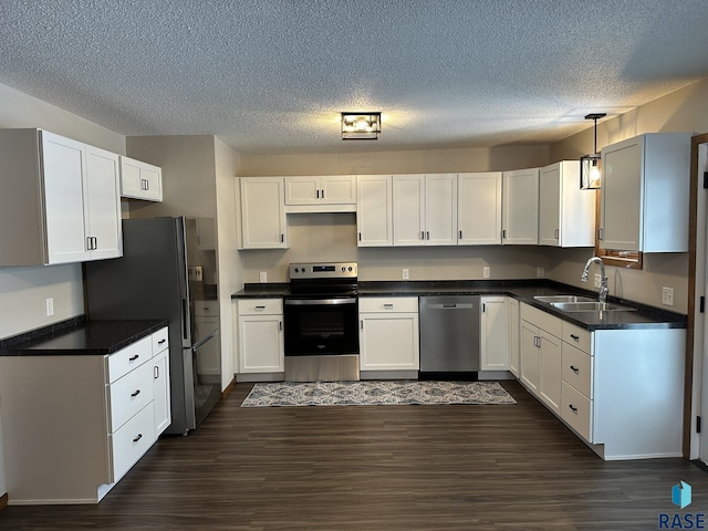 kitchen with white cabinets, sink, and appliances with stainless steel finishes