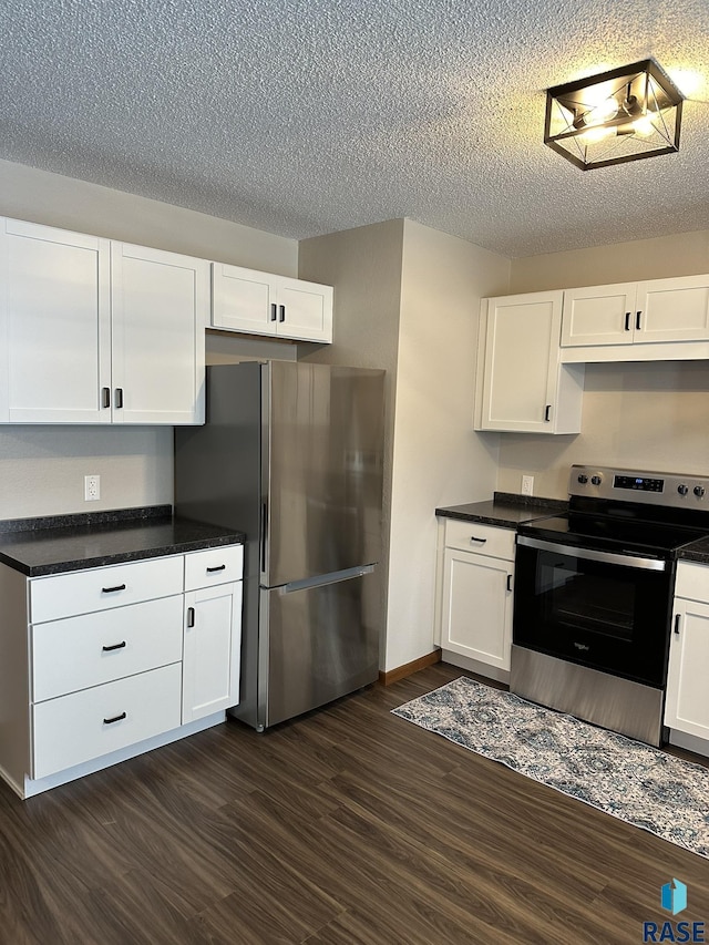 kitchen featuring dark hardwood / wood-style flooring, white cabinetry, a textured ceiling, and appliances with stainless steel finishes