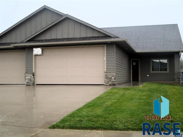 view of front of house with a garage and a front lawn