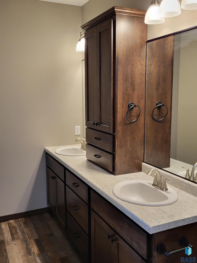 5304 S Bahnson Ave, Sioux Falls, SD 57108 - full bathroom featuring double vanity, wood finished floors, and baseboards