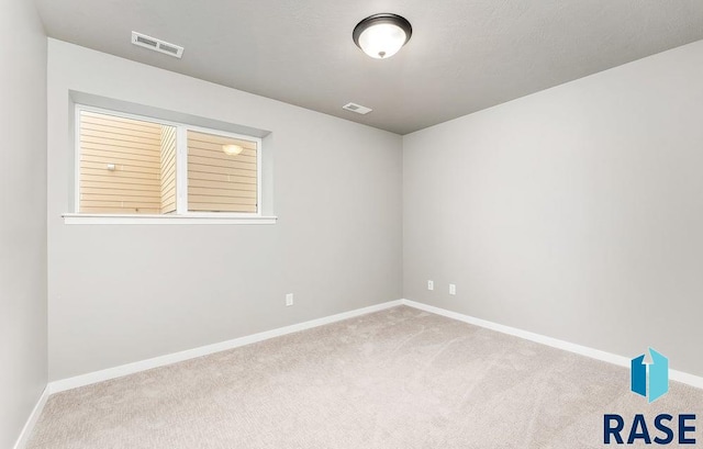 empty room featuring light carpet